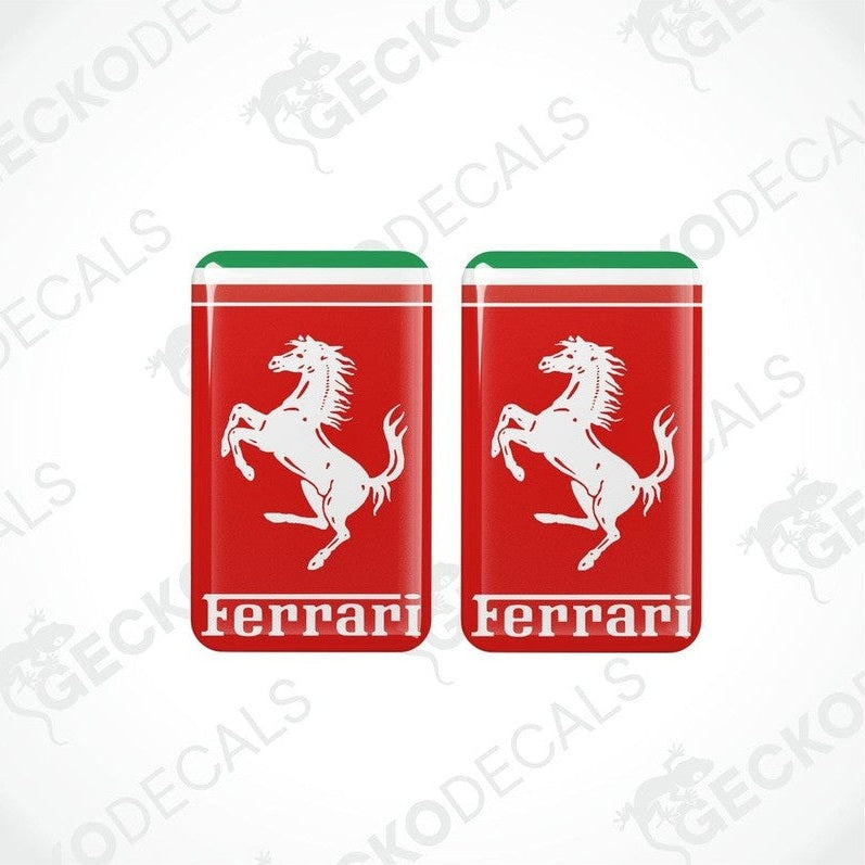 Two vinyl stickers with a depiction of a horse and the Ferrari logo on a red background with red and green stripes.