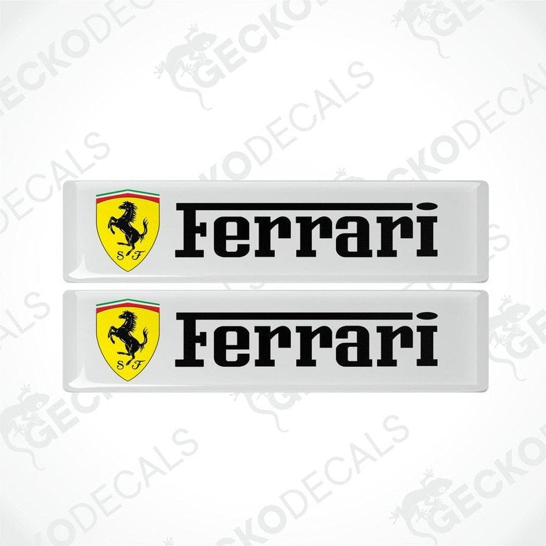 Two white, yellow, and black Ferrari car decals with the Ferrari logo and name.
