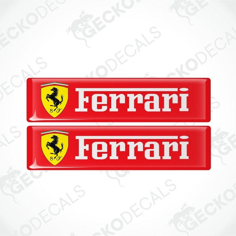 Two red, yellow, and white Ferrari car decals with the Ferrari logo and name.