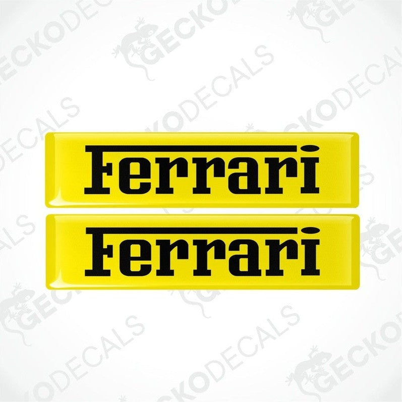 Two yellow vinyl stickers with the FERRARI logo in black text.
