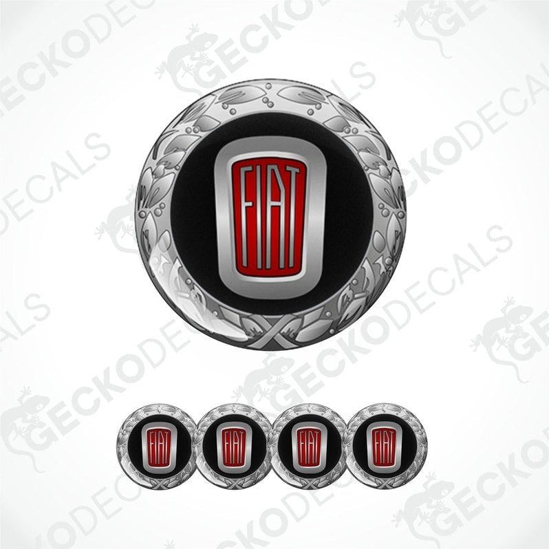 A set of vinyl decals with a polyurethane coating, featuring a central round decal with a Fiat logo and ornate designs, flanked by four additional rectangular decals.