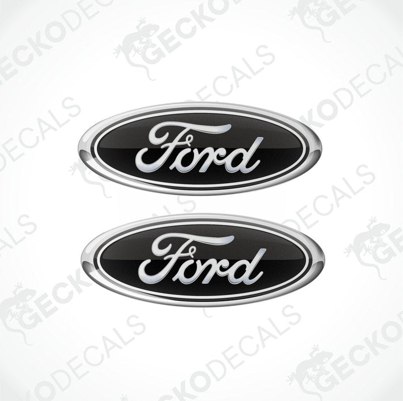 Two black oval-shaped Ford vehicle decals with white and silver text.