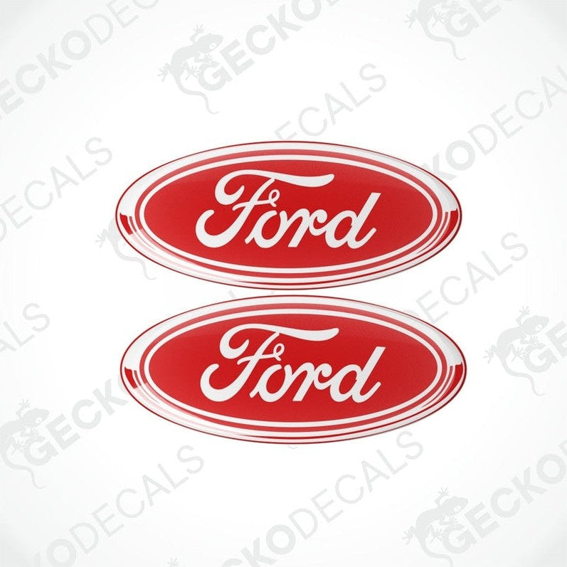 Two red oval-shaped vinyl decals with the 'Ford' brand logo in white lettering.