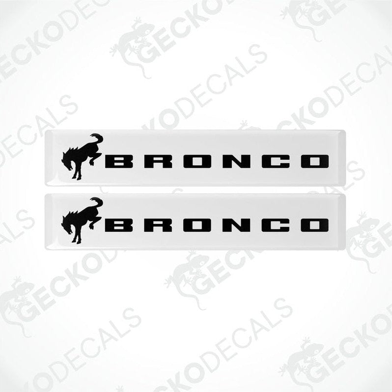 Two white and black vinyl decals with the text 'BRONCO' and a bronco animal graphic on a white background.