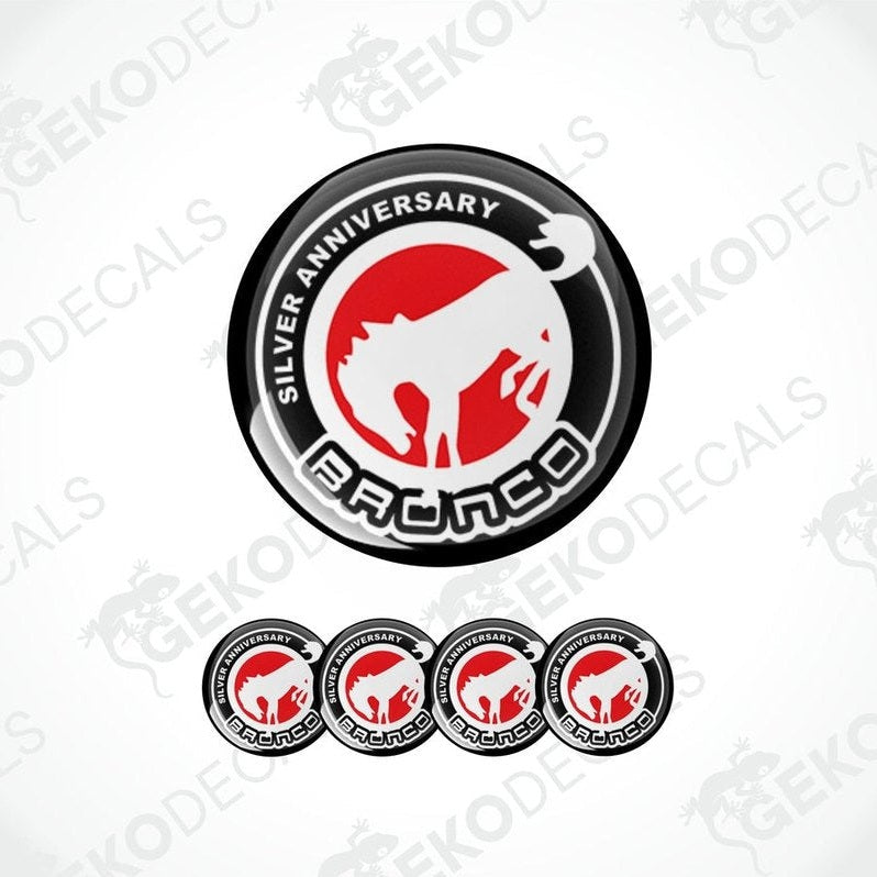 A set of four round vehicle decals featuring the text 'SILVER ANNIVERSARY' and the Ford Bronco logo in red and white on a black background.