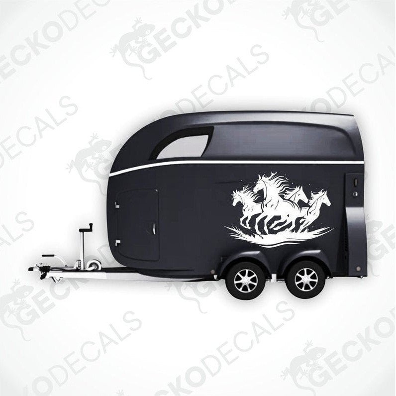 A black trailer with a die cut decal featuring four running horses on the side.