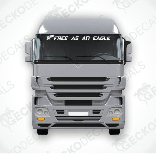 A die cut decal with the phrase 'FREE AS AN EAGLE' positioned on the front of a gray truck windshield.