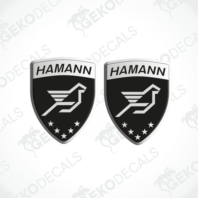 Two black, silver, and white HAMANN branded vinyl decals with a bird emblem and stars.