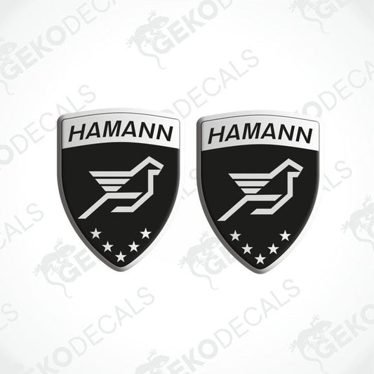 Two black, silver, and white HAMANN branded vinyl decals with a bird emblem and stars.