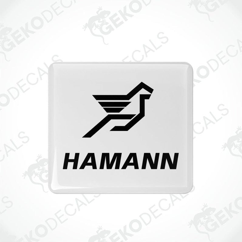 White vinyl stickers with the HAMANN logo, one with the logo facing up and the other with the logo facing down.