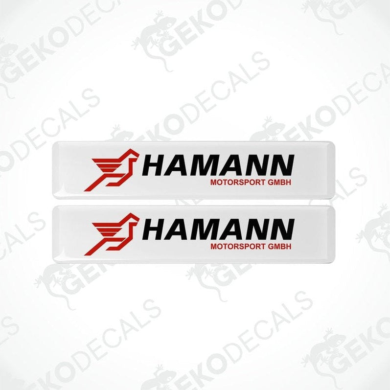 Two rectangular white vinyl decals with the red and black HAMANN Motorsport GMBH logo.