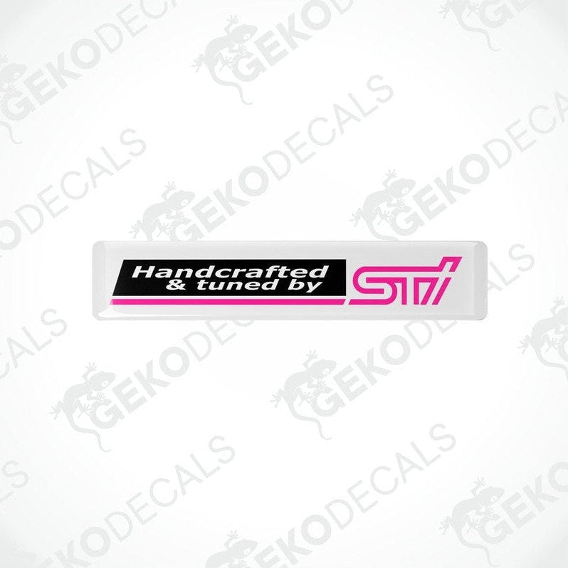  White vinyl stickers with 'HANDCRAFTED & TUNED BY STI' text, featuring a pink and black color scheme.