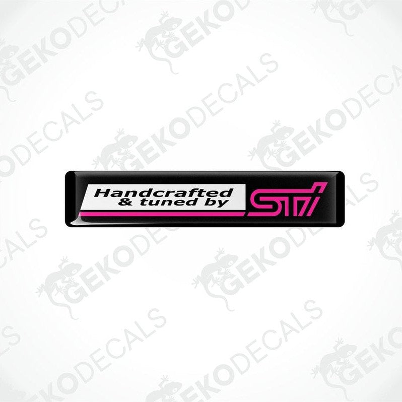 Black vinyl stickers with 'HANDCRAFTED & TUNED BY STI' text, featuring a pink and withe color scheme.