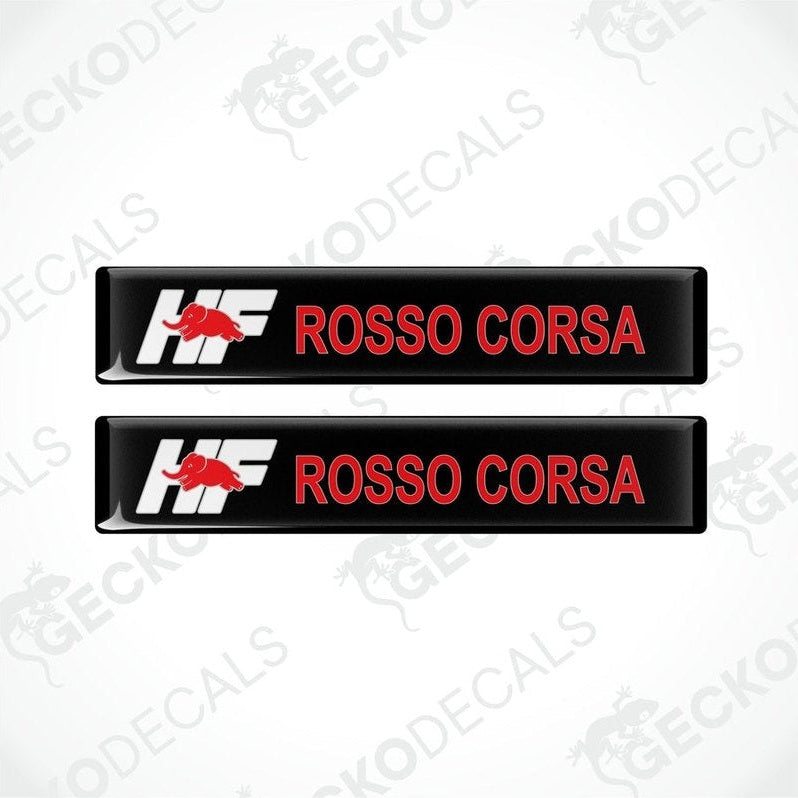 Two black vinyl decals with 'LANCIA ROSSO CORSA' text in white and red