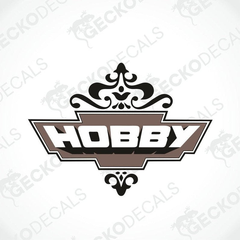 A die cut sticker with the word 'HOBBY' printed in a decorative font, predominantly brown and white in color, with a cut-out shape around the text.