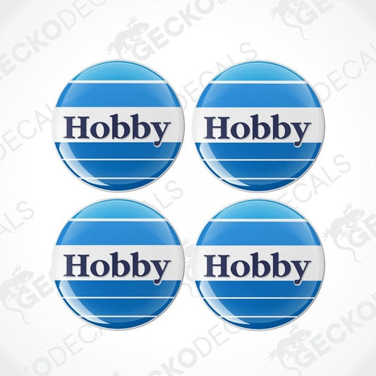 A set of four blue and white circular vinyl decals with the word 'HOBBY' in the center.