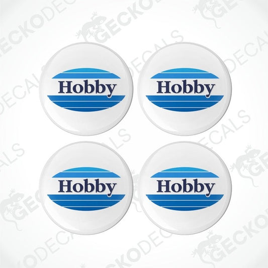 Four white, blue, and gray dome-shaped epoxy decals with the word 'Hobby' printed on them.