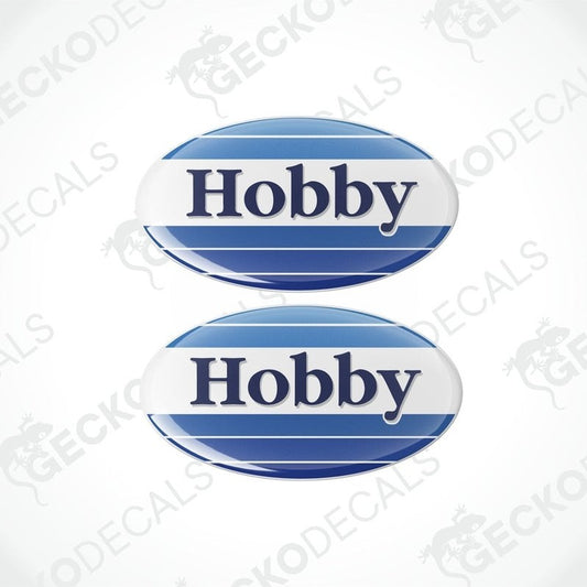 Two blue and white round vinyl stickers with the word 'HOBBY' in the center.