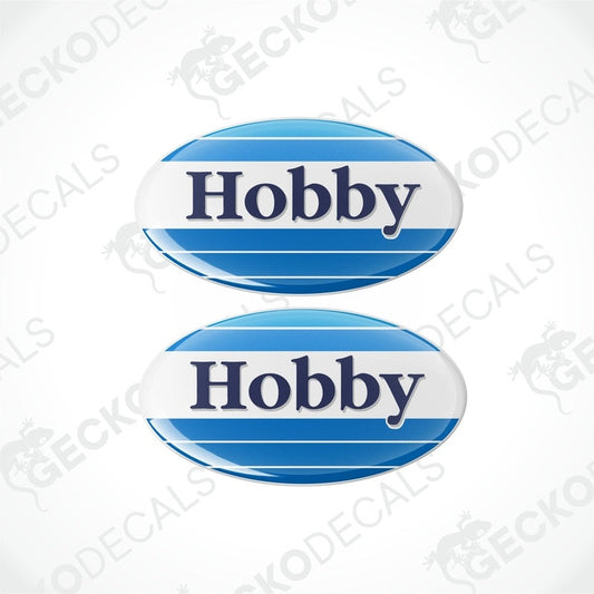 Two blue and white round vinyl stickers with the word 'HOBBY' in the center.