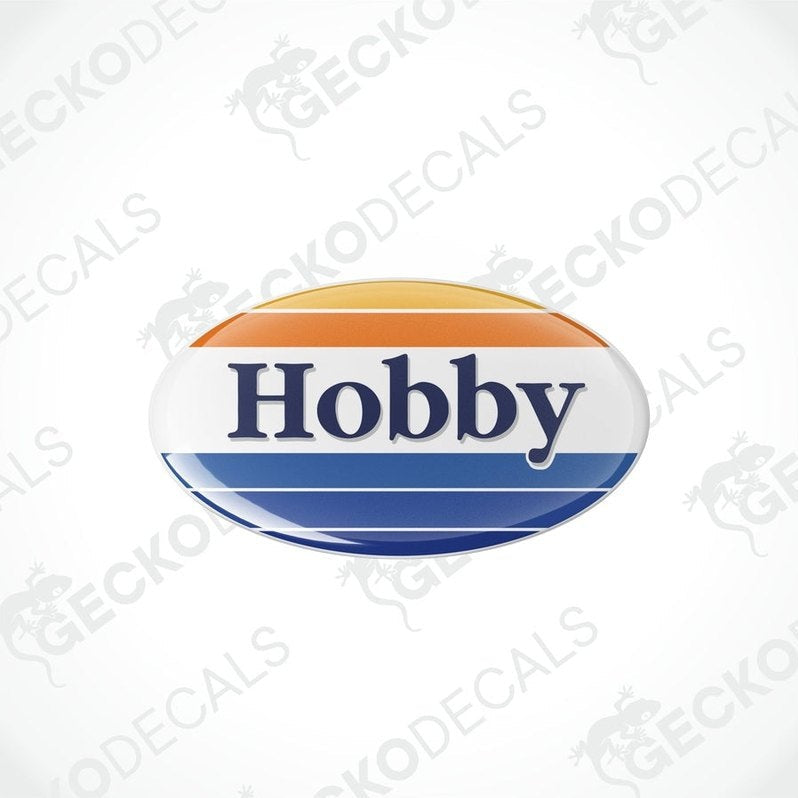 Two round vinyl decals with the word 'HOBBY' in bold letters, one above the other. The decals have a blue background with an orange and white border.