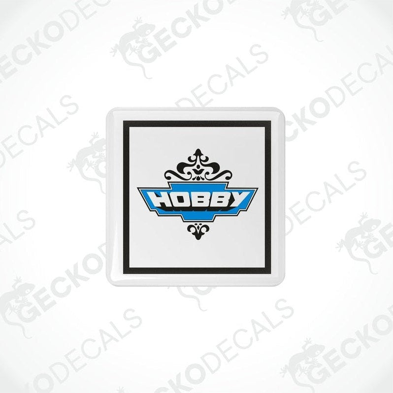 Single square HOBBY vinyl decal with glossy domed epoxy finish and ornate scrollwork