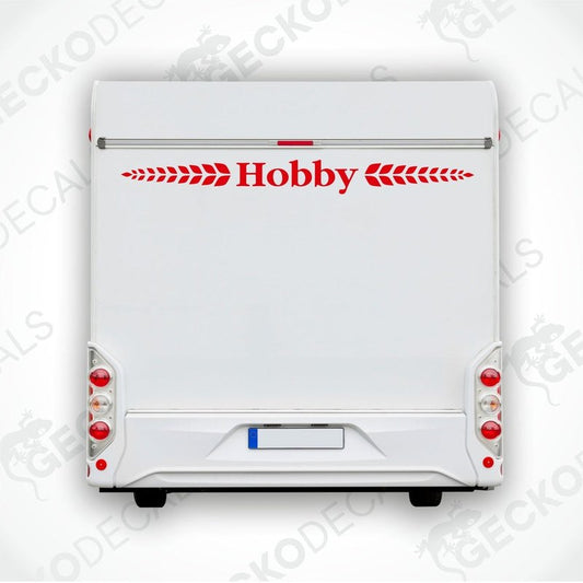 A white caravan with a red 'Hobby' brand decal on the rear side.