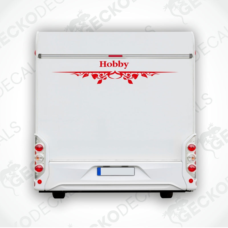 A white caravan with a red and black 'HOBBY' decal on the rear side.