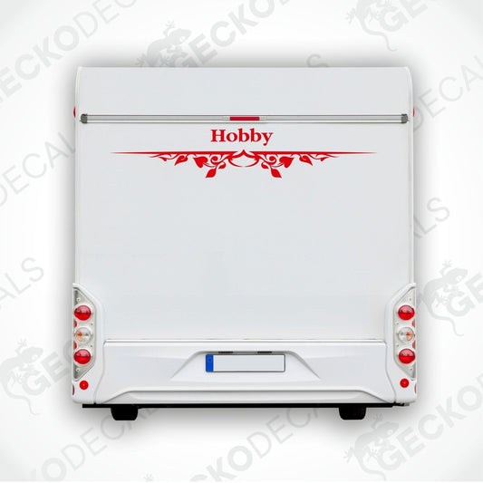 A white caravan with a red and black 'HOBBY' decal on the rear side.