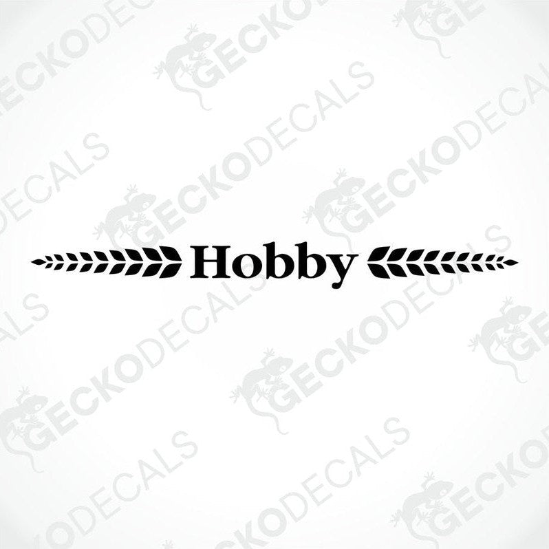 A white caravan with a red 'Hobby' brand decal on the rear side.