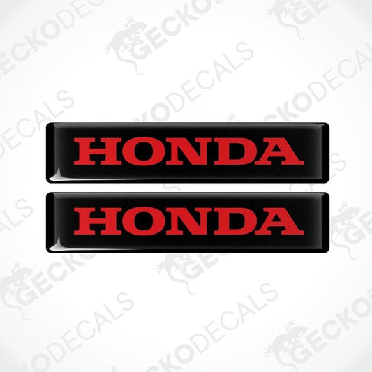 Two rectangular black vinyl decals with the word 'HONDA' written in bold red letters.