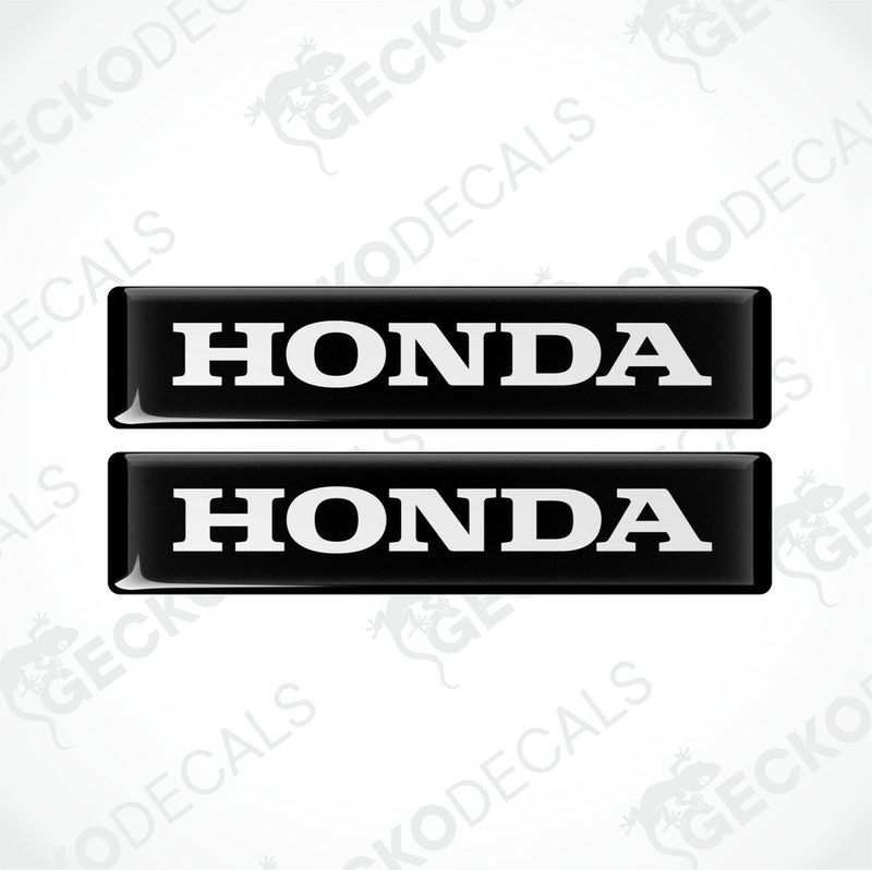 Two black and white rectangular car decals with the text 'HONDA' on them.