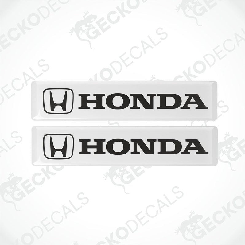 Two white vinyl stickers with the Honda logo in black.