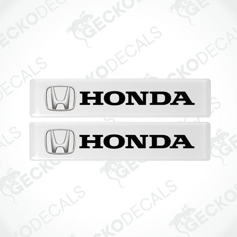Two white vinyl decals with the black text 'HONDA' and the iconic HONDA logo on each decal.