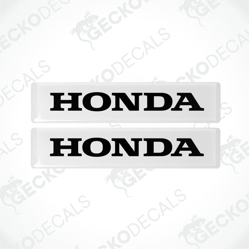 Two white and white rectangular car decals with the text 'HONDA' on them.