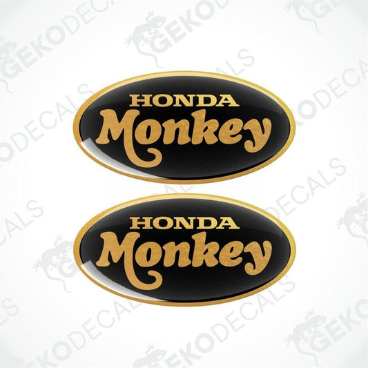 Two Honda Monkey decals with gold text on a black background.
