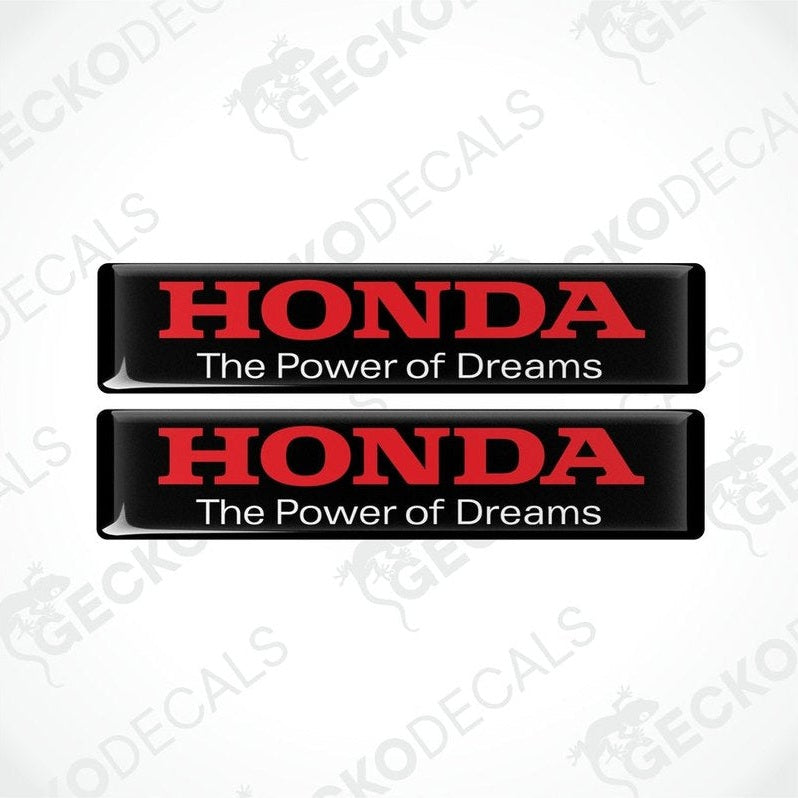 Two rectangular black vinyl decals with red text that reads 'HONDA The Power of Dreams'