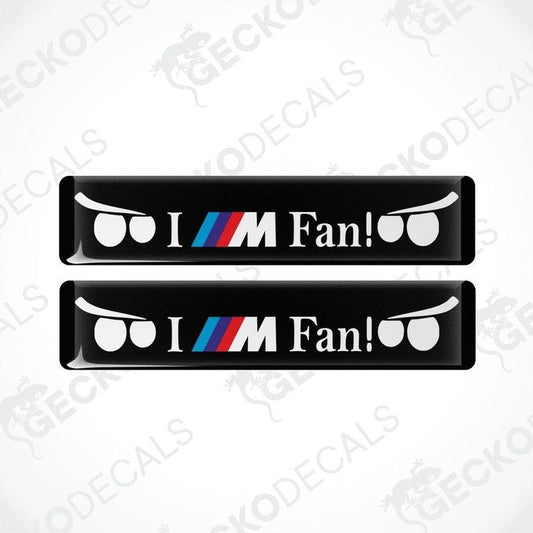 Two black vinyl decals with 'I M Fan!' text and BMW logo in white and color accents