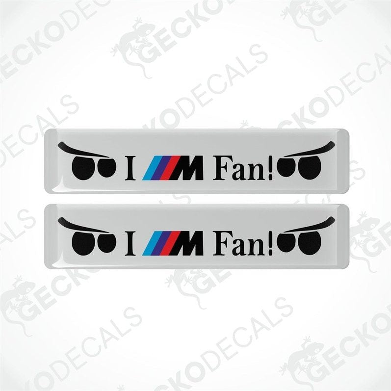 Two white vinyl decals with 'I M Fan!' text and BMW logo in black and color accents