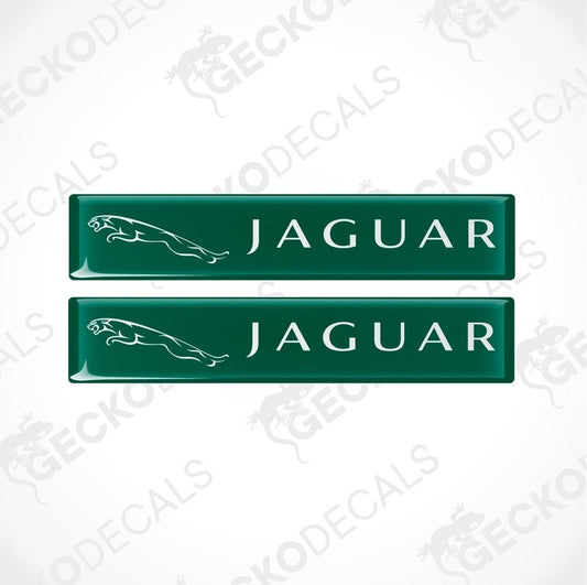 Two green rectangular car decals with the word 'JAGUAR' written on them in white lettering, along with the image of a jaguar in white.