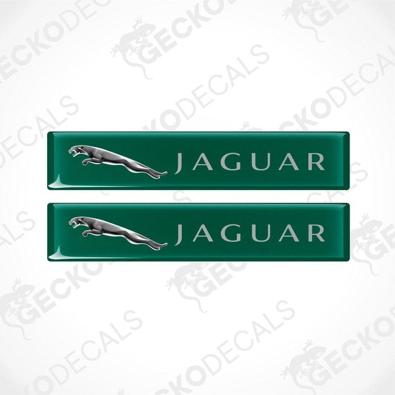 Two green rectangular car decals with the Jaguar brand logo and name written on them.