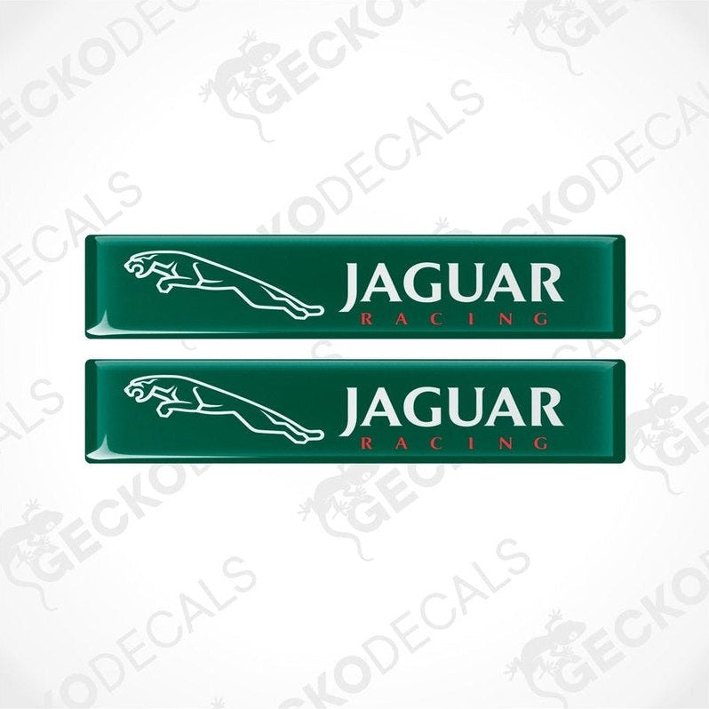Two green rectangular car decals with the text 'JAGUAR Racing' on them.