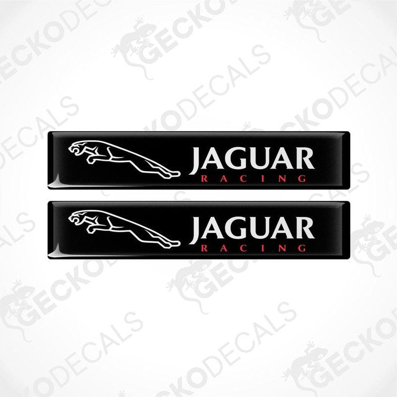 Two black rectangular car decals with the text 'JAGUAR Racing' on them.