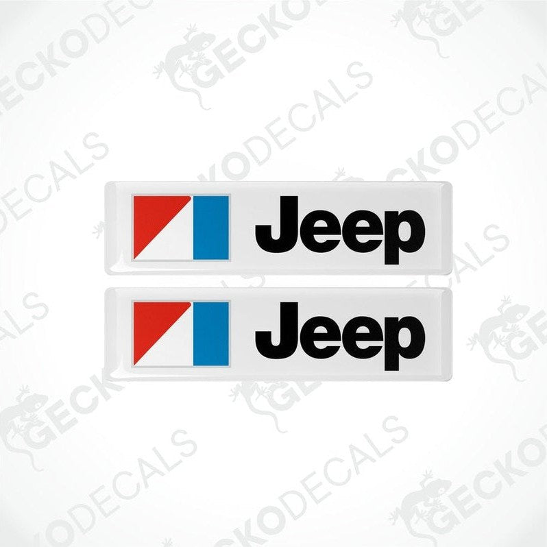 Two rectangular Jeep branded vinyl decals with a red, black, and blue color scheme.