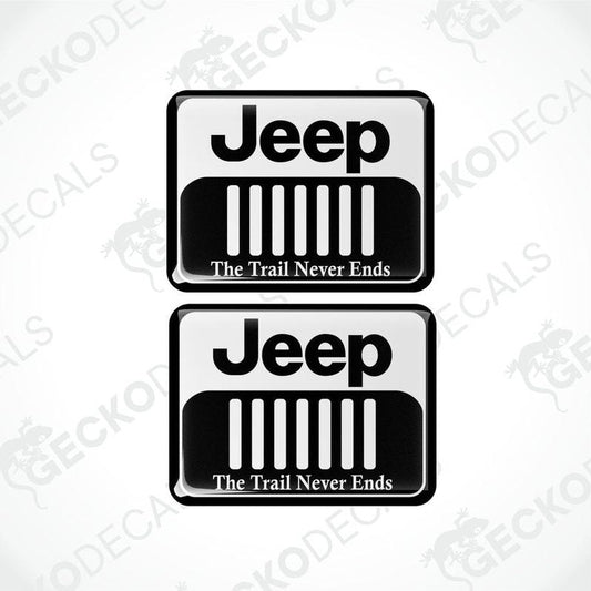 Two black vinyl stickers with a white JEEP logo and the text 'THE TRAIL NEVER ENDS' below it.