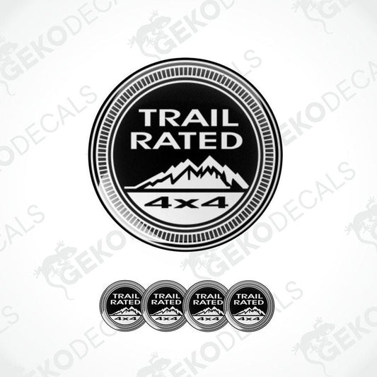 A set of four black vinyl stickers with the text 'TRAIL RATED 4X4' and a mountain range illustration in the center.