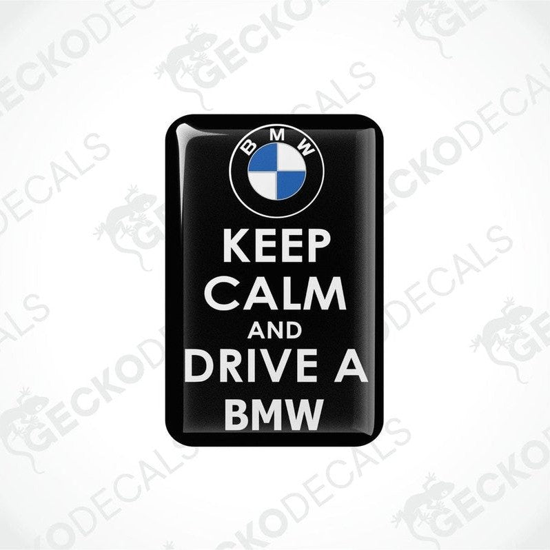 Rectangular black vinyl decals with the text 'KEEP CALM AND DRIVE A BMW' in white, and the BMW logo in blue and white.
