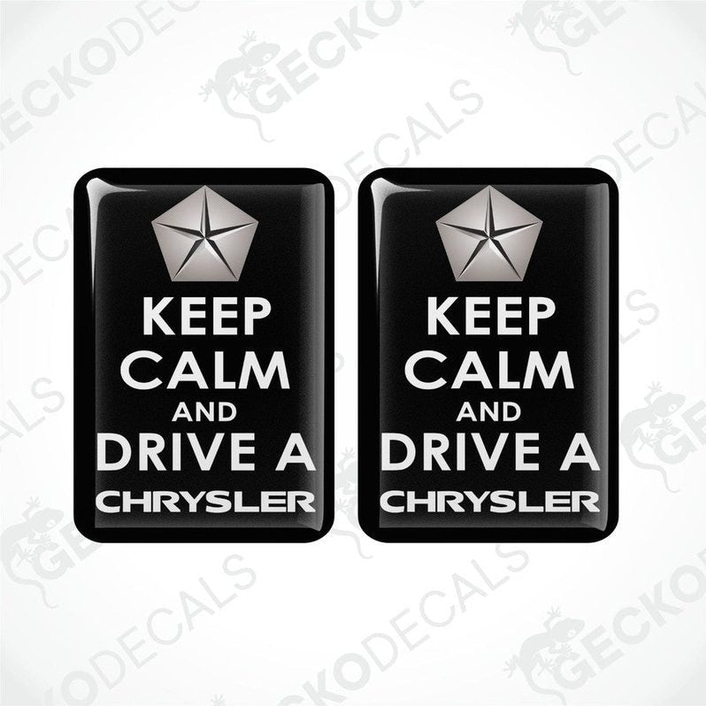 Two rectangular black vehicle decals with white text and a silver star symbol, one saying 'KEEP CALM AND DRIVE A CHRYSLER'.