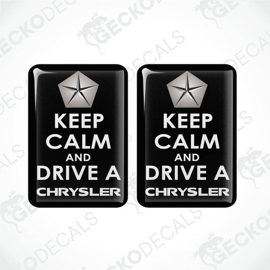 Two rectangular black vehicle decals with white text and a silver star symbol, one saying 'KEEP CALM AND DRIVE A CHRYSLER'.