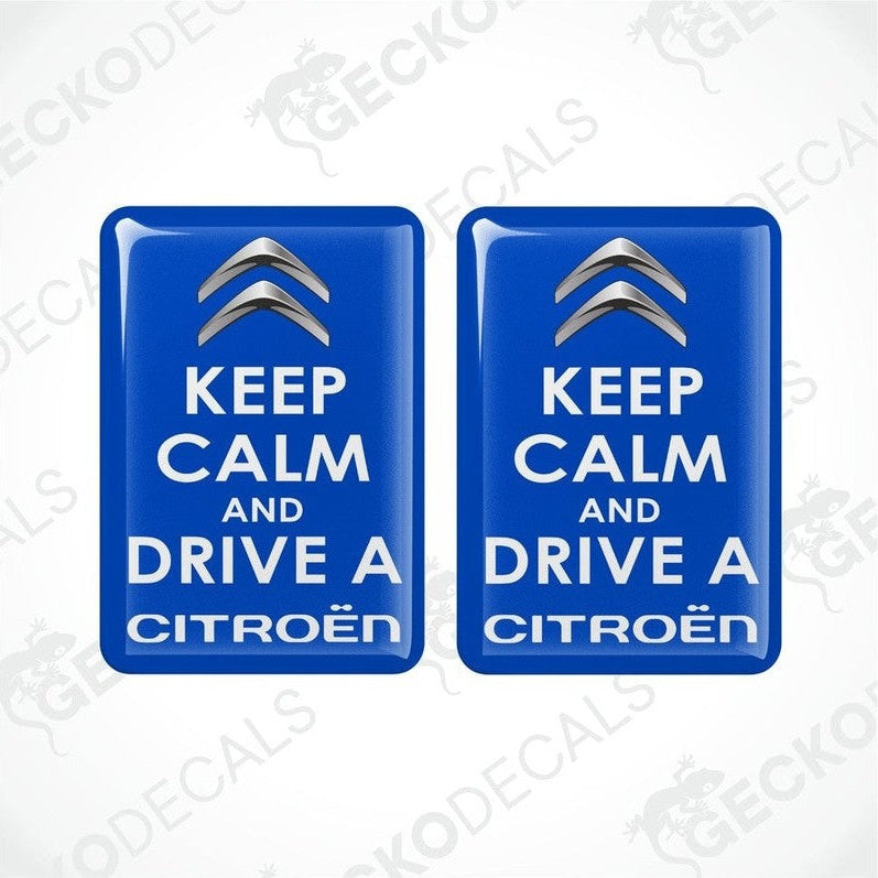 Two blue rectangular vinyl decals with the text 'KEEP CALM AND DRIVE A CITROÉN' on them.