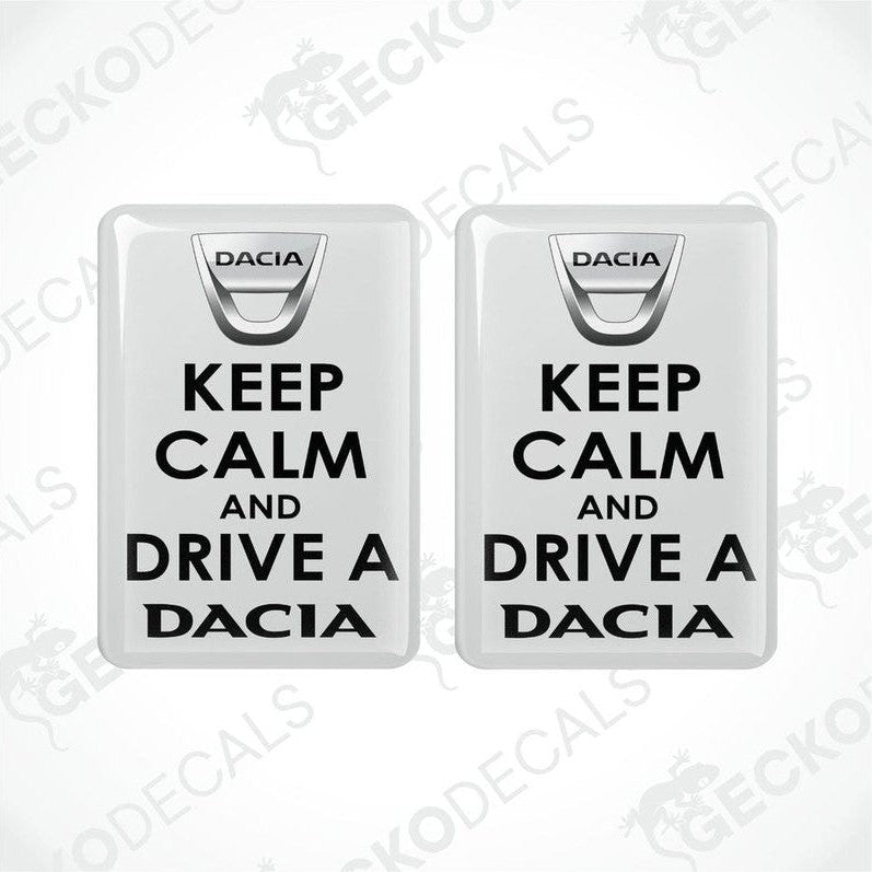Two white vinyl decals with black text saying 'KEEP CALM AND DRIVE A DACIA'